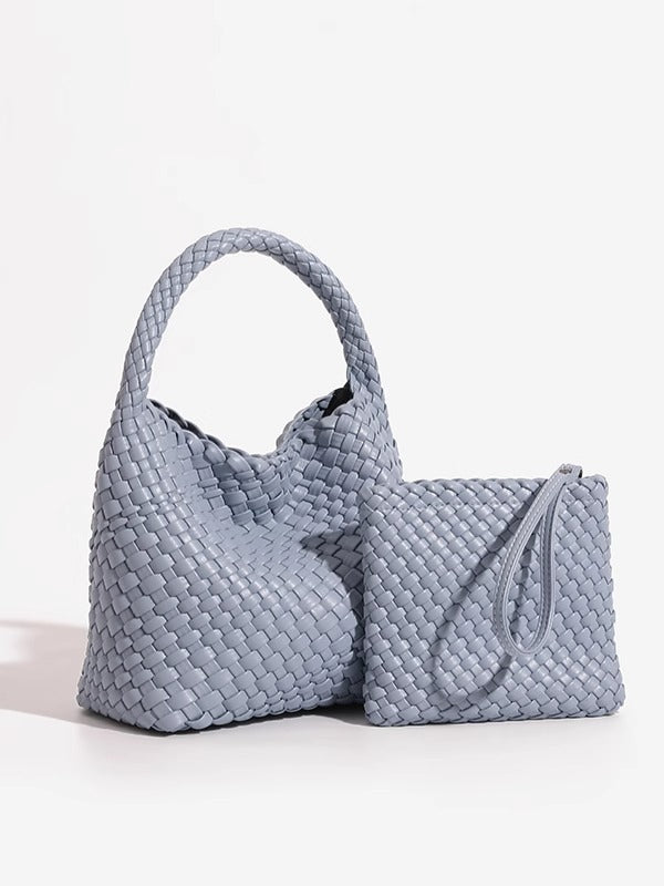 Grey woven PU bucket bag from the side with its matching zip pouch and wrist loop set beside it