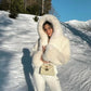 Black plush faux fur jacket back view showing the cropped length and full hood