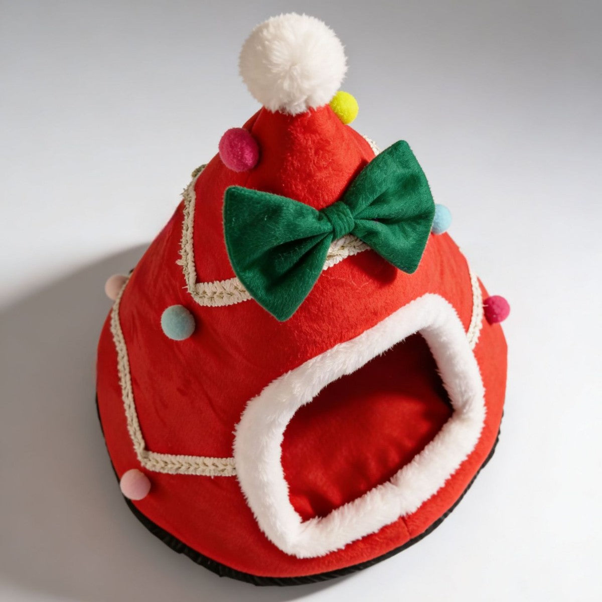 Red Christmas tree shaped pet den with a fluffy trimmed entrance