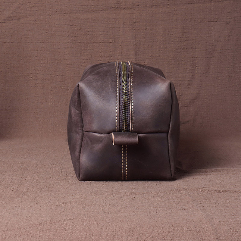 Leather dopp kit end view showing the top zipper and leather loop
