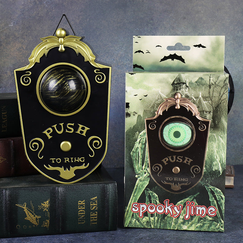 Halloween eyeball doorbell prop, scrolled PVC plaque with a domed green eye above a round push button