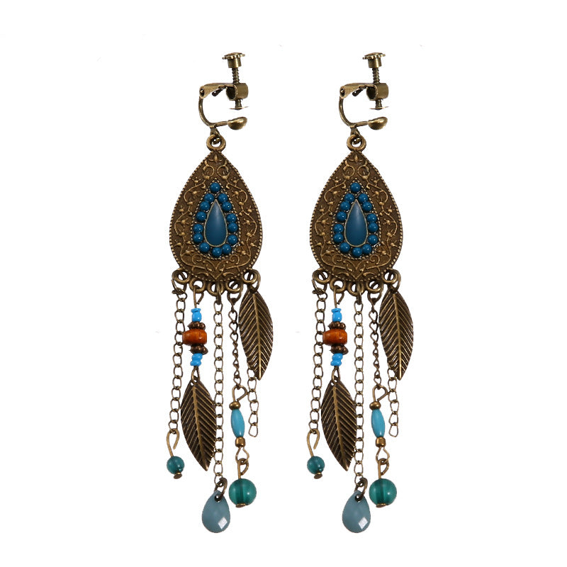 Bohemian vintage clip-on tassel drop earrings on a zinc alloy frame, handmade boho pair on white studio background