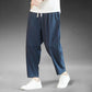 Mens loose cotton linen wide leg casual pants, ankle length with elastic drawstring waist, on model