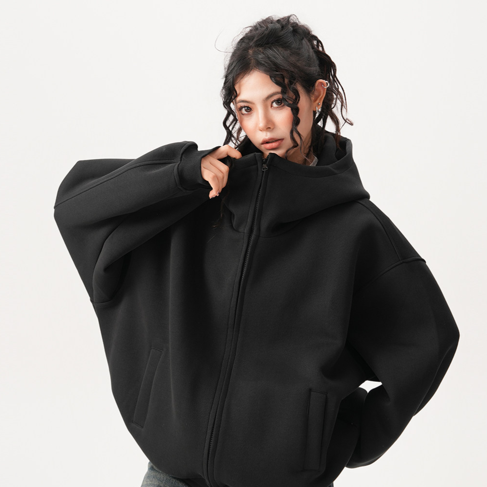 Zip up hooded sweatshirt styled open over wide leg trousers in a relaxed street look