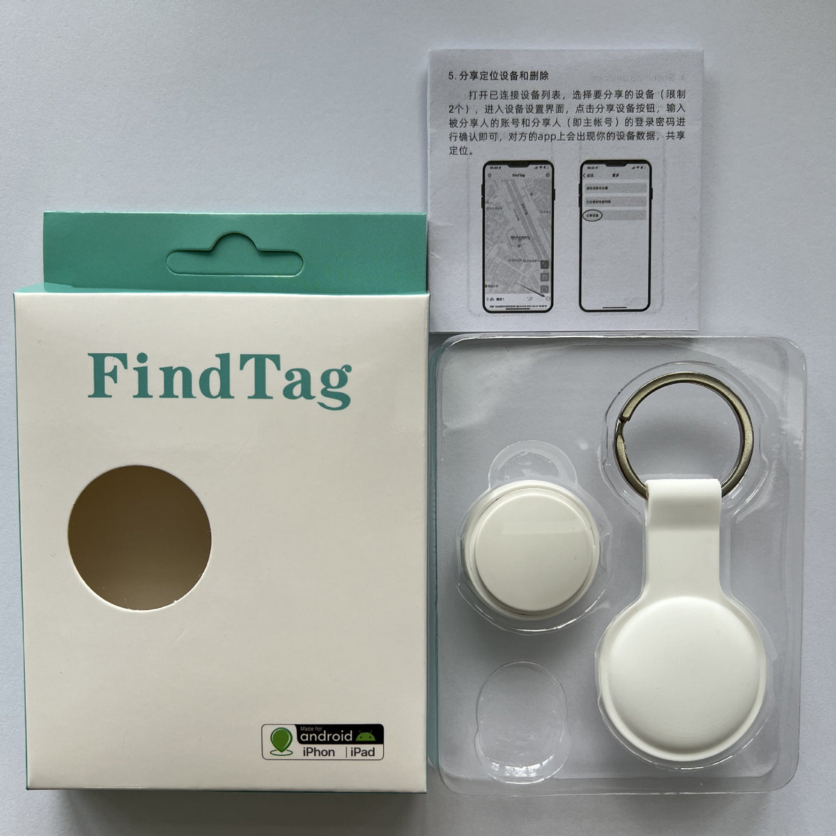 White FindTag Bluetooth tracker with its box, keychain loop holder and instruction manual