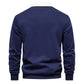 Long sleeve polo collar pullover worn under an open coat as a layer