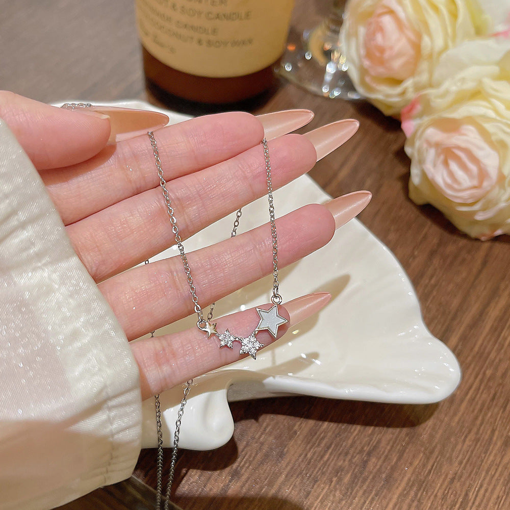Close view of the pave cubic zirconia stars on the silver tone necklace