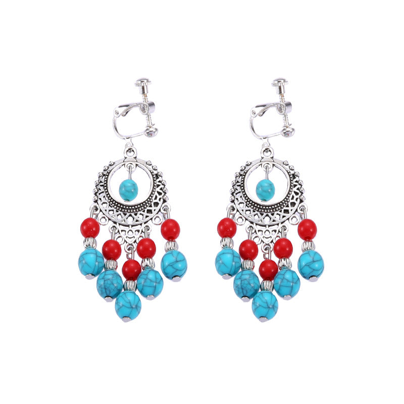 Bohemian tassel and bead clip-on drop earrings, aged tone zinc alloy frame, handmade pair on plain white background