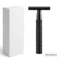 Matte black double edge safety razor next to a plain white retail box