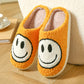 Orange plush slippers with a tufted white smiley face, size 38-39 option