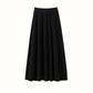 Black ribbed A-line midi skirt with tiered seams and a wide waistband, flat view on a white background