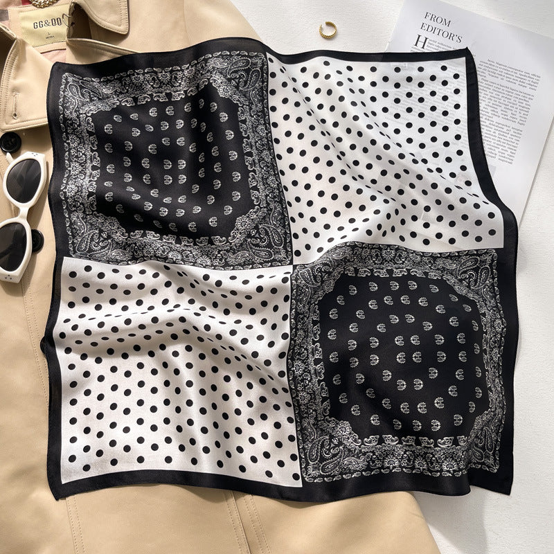 Black and white polka dot bandana printed square scarf with a satin sheen and hemmed edges, shown displayed