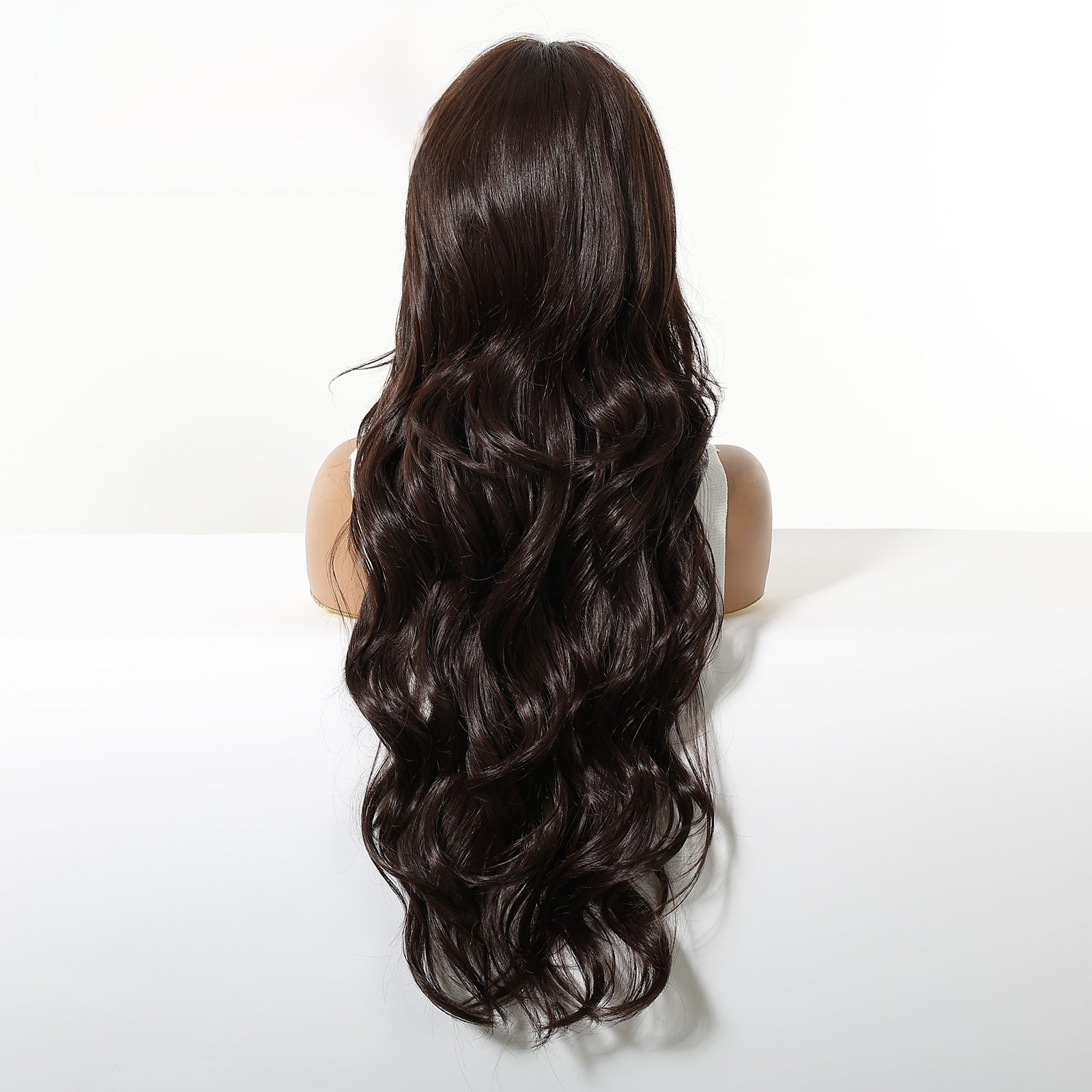 Back view of the dark brown 28 inch wig, loose waves running the full length to below the ribs