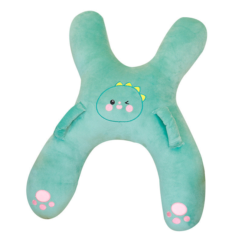 Green dinosaur X shaped plush children car neck pillow shown on its own