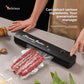 Hands using the black vacuum sealer to seal a bag of cured meat on a kitchen counter