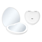 White heart shaped LED makeup mirror shown open with a lit magnified mirror and closed back