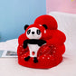 Orange plush baby floor seat with a bear at the front and a soft padded seating ring