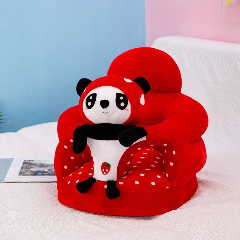 Orange plush baby floor seat with a bear at the front and a soft padded seating ring