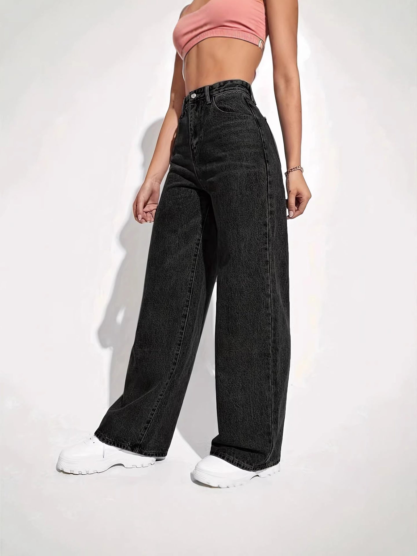 Jeans styled with a knit sweater on a wood floor at home