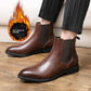 Man in striped trousers wearing brown slip-on Chelsea boots with elastic side panels, flame icon Add cotton for warmth