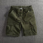 Men's loose fit cargo shorts shown flat with slant hand pockets and side cargo flap pockets