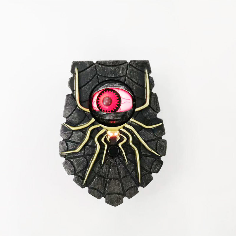 Spider red eye Halloween doorbell, a black PVC spiderweb plaque with a glowing red eyeball and push button