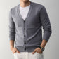 Camel mens V neck knit cardigan with a button front worn over a white tee by a model