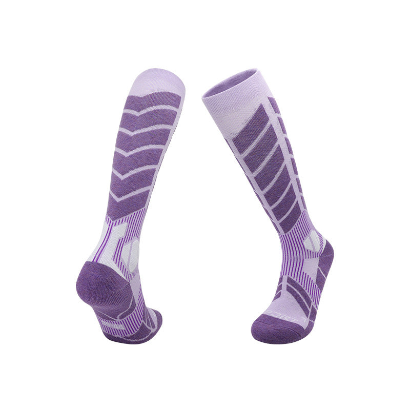 Thick knit ski socks with an arrow pattern up the shin and a padded footbed on white