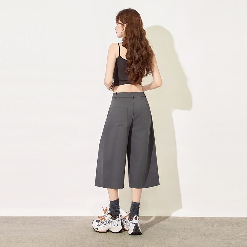 Back view of dark gray cropped wide leg suit pants with welt pockets
