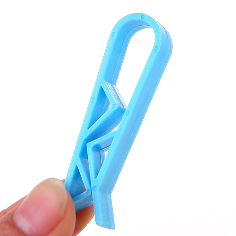 Close up of a single blue trash bag holder clip