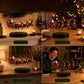 Four holiday scenes with the Santa sleigh and reindeer decoration on a mantel, a dining table and a desk