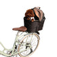 Canvas pet carrier clipped onto a bicycle steel frame for travel