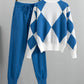 Blue argyle knit sweater with white panels and matching blue drawstring jogger pants on hangers against a white background
