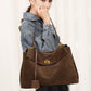 Frosted suede tote bag styled with a casual everyday outfit and crossbody strap