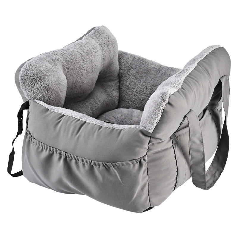 Padded car seat pet bed with raised bolster walls, carry handles and an inner clip showing the seat anchoring strap