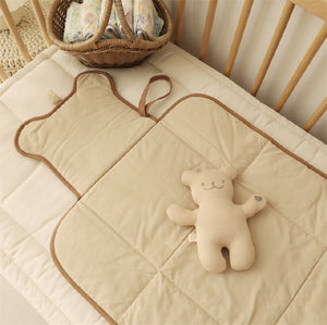 Foldable cotton baby changing pad side profile showing the quilted thickness