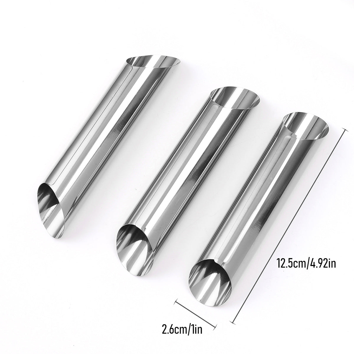 Three silver tube pastry molds 12.5 cm long and 2.6 cm across on a white background