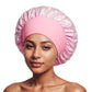 Woman wearing a light pink satin bonnet with a ruffled crown and a wide pink elastic band