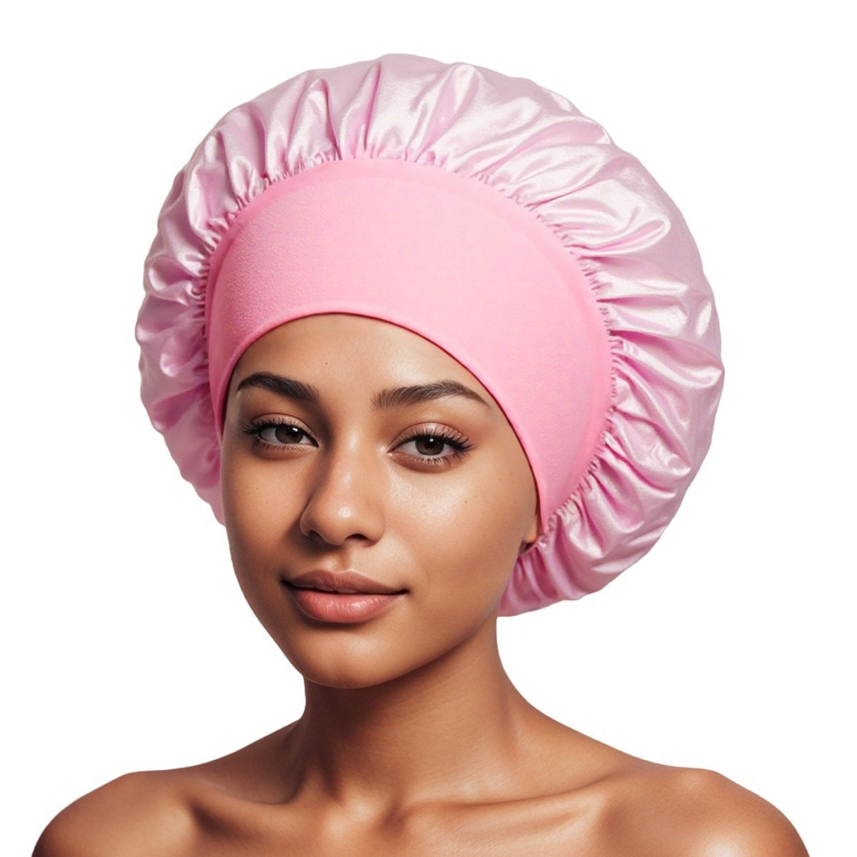 Woman wearing a light pink satin bonnet with a ruffled crown and a wide pink elastic band