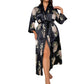 Satin robe held to show its fluid drape and contrast trim on the belt and cuffs