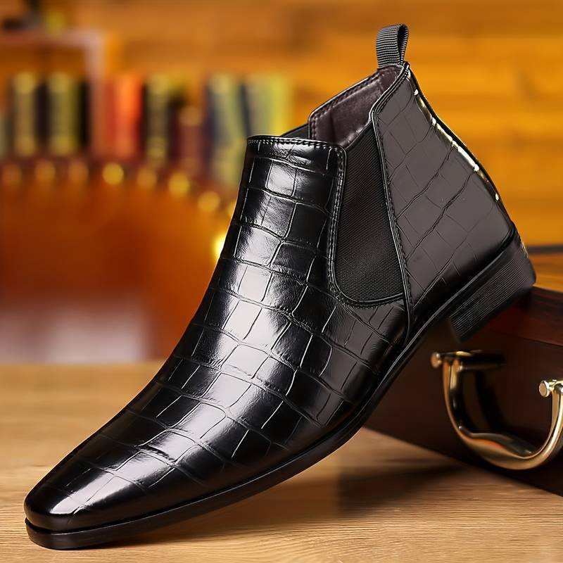 Plaid black variant, size 49: black plaid grid ankle boot with an elastic side panel on a brass-fitted wooden case