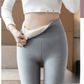 Light gray high waist leggings worn with a white crop top, the waistband pulled open to show the cream lining