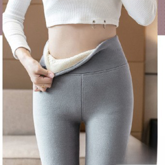 Light gray high waist leggings worn with a white crop top, the waistband pulled open to show the cream lining