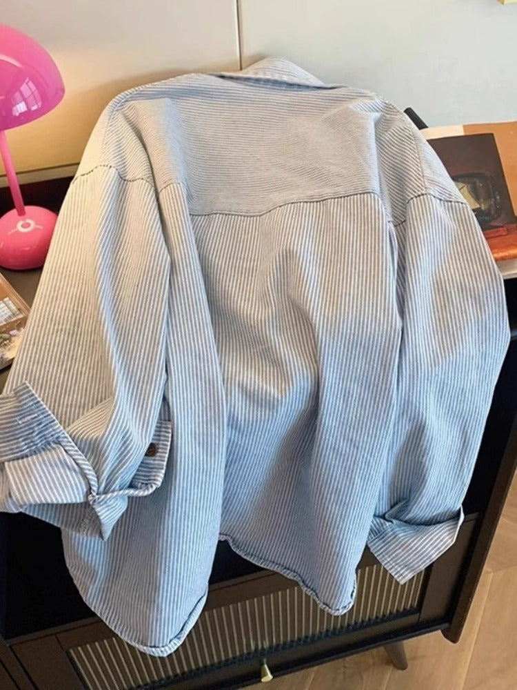 Blue striped cotton shirt tucked into trousers for a tidy daily outfit