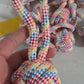 Single-Ear Ball Dog Toy option: braided multicolor rope ball with a loop held in a hand