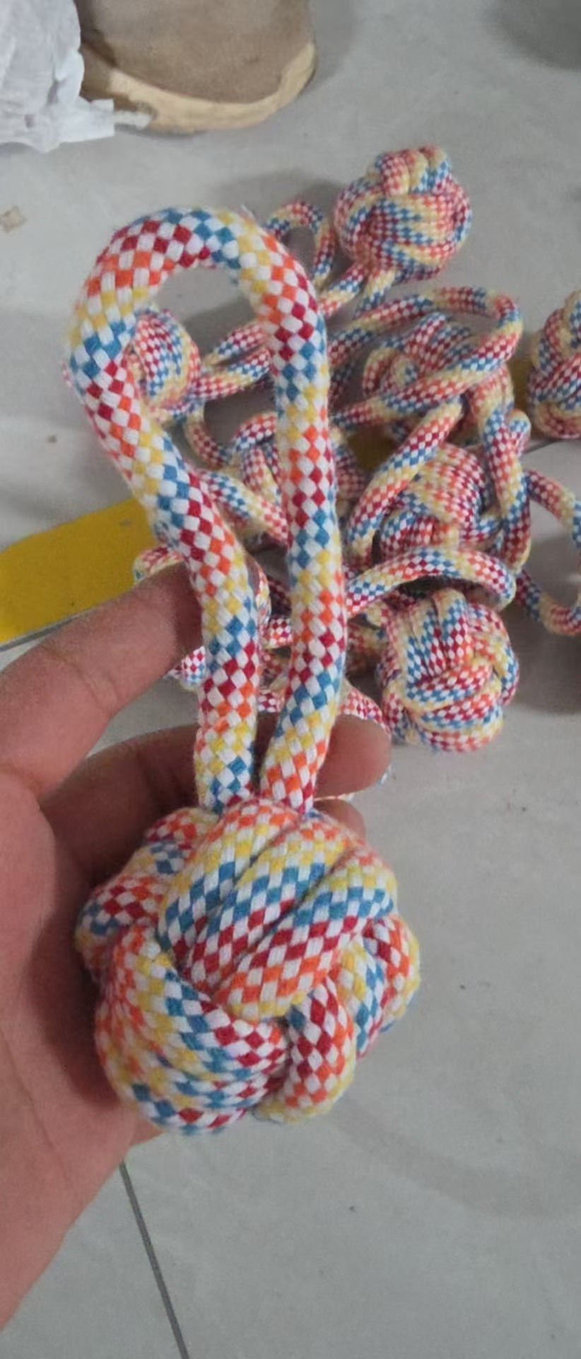 Single-Ear Ball Dog Toy option: braided multicolor rope ball with a loop held in a hand