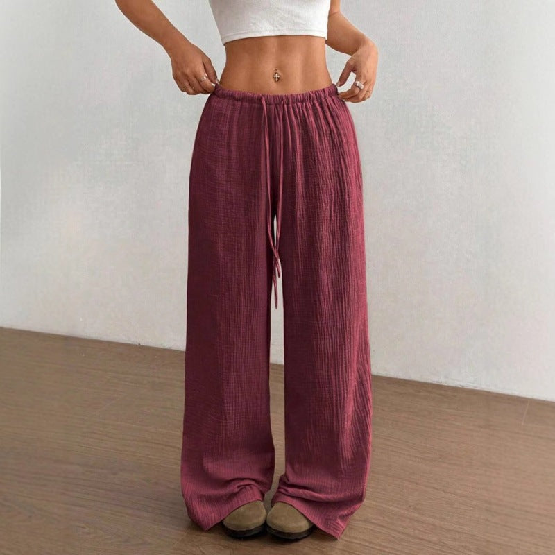 High waist wide leg crinkle cotton trousers shown front on with an elastic drawstring waist