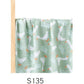 Folded cotton muslin swaddle blanket with a soft open weave and an even printed pattern