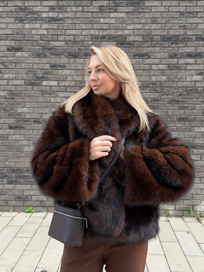 Dark red brown vegan fur short jacket with wide collar worn with brown trousers and a crossbody bag