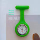 Pink silicone nurse fob watch with a quartz analog dial, front view